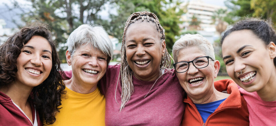 Happy multi generational women having fun together - Multiracial friends smiling on camera after sport workout outdoor - Main focus on african female face