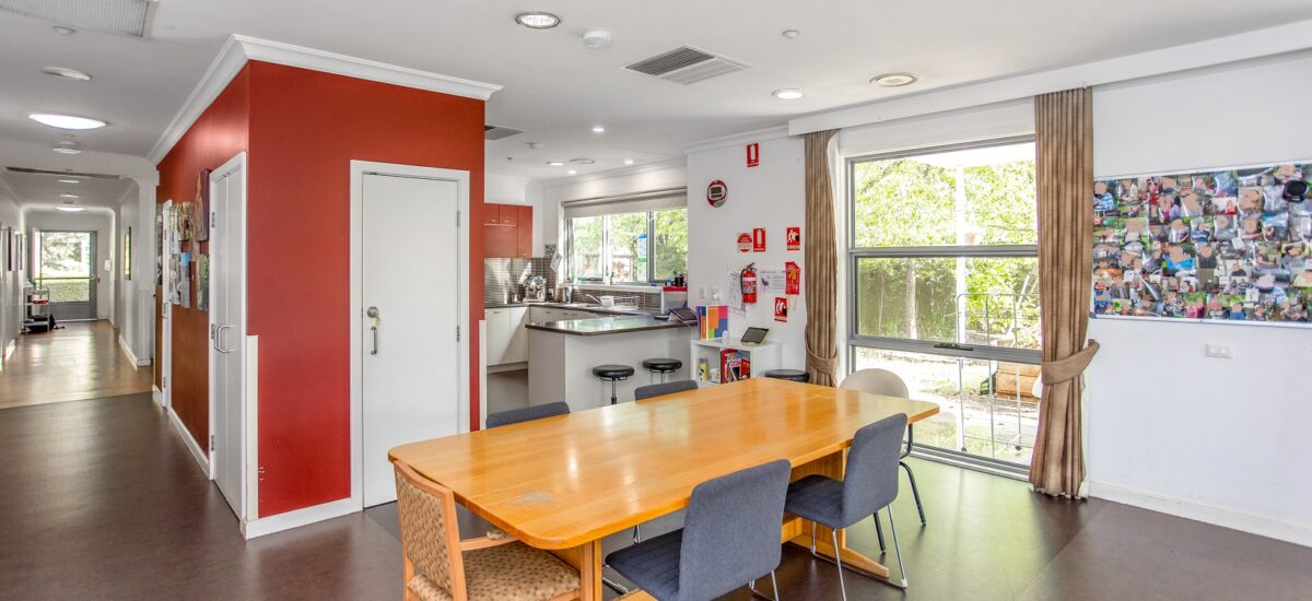 Large walkway corridor leading to an open plan kitchen and dining area