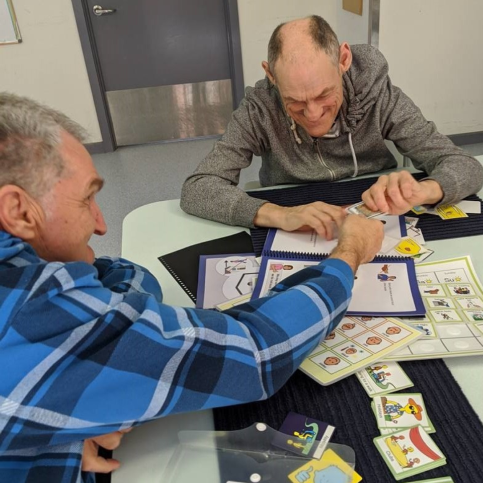 Two Scope customers at a table playing games
