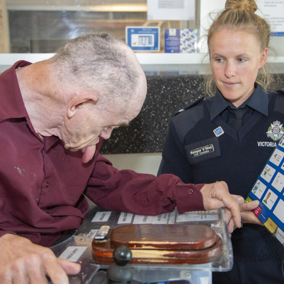 Scope customer using a communication aid book to communication an officer.